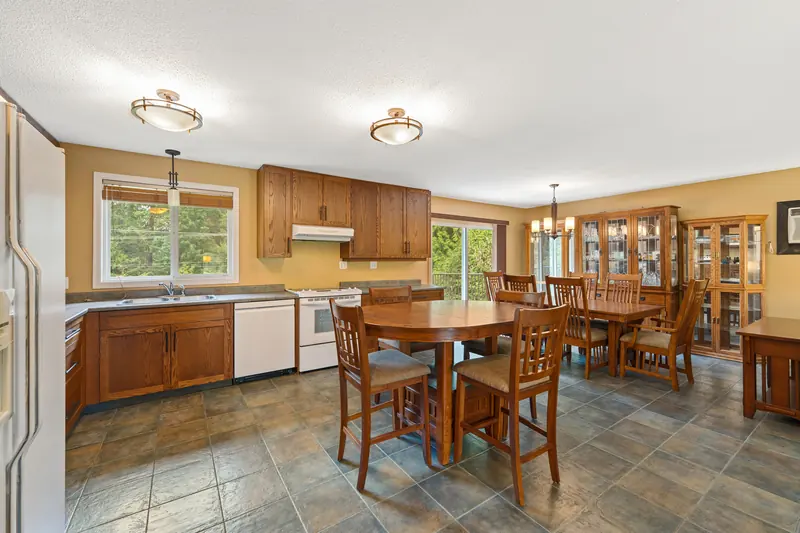 The kitchen, with wood cabinets and room for a table